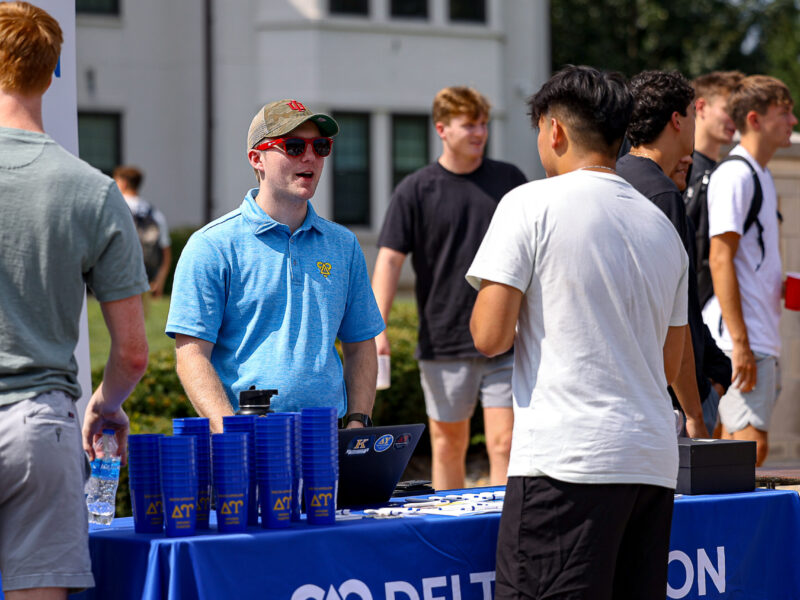 Fraternity member from Delta Epsilon talks to student during IFC Block Party at IU Bloomington on Monday, Aug. 24, 2026. (Photo by Brady Owen/Indiana University Office of Student Life)